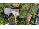 An aerial view showcases the home's location, surrounded by mature trees at 7219 Hunterdon Dr, Orlando, FL 32835