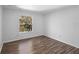 Bedroom with laminate floors and window overlooking the yard at 7219 Hunterdon Dr, Orlando, FL 32835