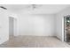 Bright bedroom with a ceiling fan, closet, and sliding glass doors at 7219 Hunterdon Dr, Orlando, FL 32835