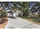 View of the driveway leading to an attached two-car garage on a sunny day at 7219 Hunterdon Dr, Orlando, FL 32835
