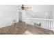 Upstairs landing with white banister and hardwood flooring at 7219 Hunterdon Dr, Orlando, FL 32835