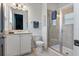 Bright bathroom with granite vanity, tile flooring, glass shower, and white fixtures at 7456 Marker Ave, Kissimmee, FL 34747