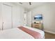 Bright bedroom features a TV, a closet, and a light colored bedspread at 7456 Marker Ave, Kissimmee, FL 34747
