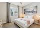 Bedroom featuring a queen bed, large window with curtains, and a cityscape wall art at 7456 Marker Ave, Kissimmee, FL 34747