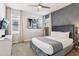 Bedroom featuring stylish wallpaper, plush bed, neutral curtains, and bright windows at 7456 Marker Ave, Kissimmee, FL 34747