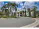 Stately clubhouse with landscaped roundabout and decorative pillars offers an inviting entrance at 7456 Marker Ave, Kissimmee, FL 34747