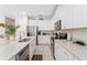 Bright kitchen features white cabinetry, stainless steel appliances, and granite countertops at 7456 Marker Ave, Kissimmee, FL 34747