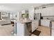 Kitchen island features a sink and stainless steel dishwasher with an adjacent breakfast bar at 7456 Marker Ave, Kissimmee, FL 34747