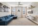Spacious living room with a comfortable blue sectional sofa and decorative aviation accents at 7456 Marker Ave, Kissimmee, FL 34747