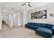 Relaxing upstairs living area featuring aviation décor and a comfortable blue sectional sofa at 7456 Marker Ave, Kissimmee, FL 34747