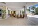 Comfortable outdoor seating area with neutral tones, offering a relaxing spot with lush landscaping and natural light at 7456 Marker Ave, Kissimmee, FL 34747