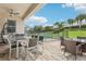 Covered patio featuring dining set, patio furniture, and a view to the fenced backyard at 7456 Marker Ave, Kissimmee, FL 34747