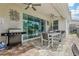 Covered patio featuring outdoor dining set, grill, and view of yard and pool at 7456 Marker Ave, Kissimmee, FL 34747