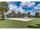 Inviting sand volleyball court surrounded by palm trees, creating a recreational space for outdoor activities and fun at 7456 Marker Ave, Kissimmee, FL 34747