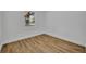 Clean, bright bedroom with natural light and wood-look floors at 7601 Aviano Ave, Orlando, FL 32819