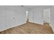 Clean bedroom with wood-look floors and bright white walls at 7601 Aviano Ave, Orlando, FL 32819