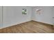 Clean, bright bedroom with natural light and wood-look floors at 7601 Aviano Ave, Orlando, FL 32819