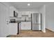 Bright kitchen features stainless steel appliances, granite countertops, and white cabinetry at 7601 Aviano Ave, Orlando, FL 32819