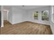 Bright living room with neutral walls, modern flooring, and a large window providing ample sunlight at 7601 Aviano Ave, Orlando, FL 32819
