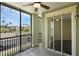 A screened balcony with a ceiling fan, providing a view of the community pool at 8192 Boat Hook Loop # 205, Windermere, FL 34786