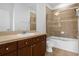 A bathroom featuring a vanity with a sink, a mirror, and a bathtub with glass doors at 8192 Boat Hook Loop # 205, Windermere, FL 34786
