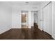 A bedroom with dark wood floors and white walls, with a bathroom and closet nearby at 8192 Boat Hook Loop # 205, Windermere, FL 34786