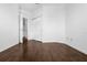 A bright bedroom with dark wood floors and access to a closet and bathroom at 8192 Boat Hook Loop # 205, Windermere, FL 34786