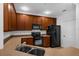 Traditional kitchen with wooden cabinets and black appliances at 8192 Boat Hook Loop # 205, Windermere, FL 34786