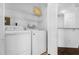 A laundry room with a washer, dryer, and shelving for organized storage at 8192 Boat Hook Loop # 205, Windermere, FL 34786