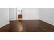 An empty living room with wood floors that connects to a bathroom through a doorway at 8192 Boat Hook Loop # 205, Windermere, FL 34786