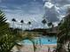 Community pool surrounded by lush greenery, offering a refreshing and tropical escape for residents at 8192 Boat Hook Loop # 205, Windermere, FL 34786