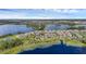 An aerial view of this home in a lakeside community, showcasing its location among lush greenery and waterways at 10117 Atwater Bay Dr, Winter Garden, FL 34787