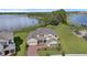 An aerial view of this waterfront home showcasing its brick driveway, lush landscaping, and proximity to the lake at 10117 Atwater Bay Dr, Winter Garden, FL 34787