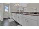 Bright bathroom featuring double sinks with granite countertops and modern vanities at 11158 Hollow Bay Dr, Winter Garden, FL 34787