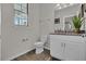 A bathroom featuring a single vanity with granite countertop and a toilet at 11158 Hollow Bay Dr, Winter Garden, FL 34787