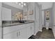 Elegant bathroom with double vanities, granite countertops, modern fixtures, and stylish wall decor at 11158 Hollow Bay Dr, Winter Garden, FL 34787