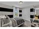 Contemporary bedroom with striped walls, a cozy bed, and natural light streaming through the window at 11158 Hollow Bay Dr, Winter Garden, FL 34787