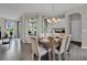 Dining room area with modern light fixture and views, seamlessly blending with other living spaces at 11158 Hollow Bay Dr, Winter Garden, FL 34787