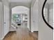 Inviting hallway with wood-look tile and archway leading to an open-concept living area at 11158 Hollow Bay Dr, Winter Garden, FL 34787