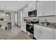 Modern kitchen featuring stainless steel appliances, granite countertops, and ample white cabinetry at 11158 Hollow Bay Dr, Winter Garden, FL 34787