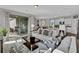 Bright living room boasts tile flooring, contemporary decor, and sliding doors to the patio at 11158 Hollow Bay Dr, Winter Garden, FL 34787