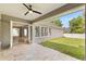 Inviting outdoor patio with a ceiling fan, tiled floor, and view to the spacious backyard at 11333 Camden Park Dr, Windermere, FL 34786