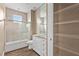 Elegant bathroom with tub, granite countertop, a sliding glass door, and open shelving at 11333 Camden Park Dr, Windermere, FL 34786