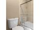 Bright bathroom with a tiled shower-tub, glass door, and neutral color palette at 11333 Camden Park Dr, Windermere, FL 34786