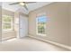 Bright, carpeted bedroom featuring a ceiling fan, natural light, and a calming color palette at 11333 Camden Park Dr, Windermere, FL 34786