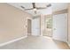 Comfortable bedroom with neutral carpet, a ceiling fan, natural light, and ample closet space at 11333 Camden Park Dr, Windermere, FL 34786