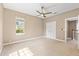 Bright bedroom featuring a ceiling fan, ample closet space, and two large windows at 11333 Camden Park Dr, Windermere, FL 34786