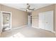 Bedroom with ceiling fan, closet, and an en-suite bathroom at 11333 Camden Park Dr, Windermere, FL 34786