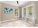 Bright bedroom with a ceiling fan, tile floors, and multiple windows offering natural light at 11333 Camden Park Dr, Windermere, FL 34786