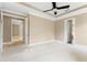 Spacious bedroom with a ceiling fan and neutral carpet at 11333 Camden Park Dr, Windermere, FL 34786